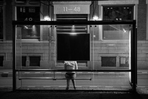 Woman waiting at a bus stop
