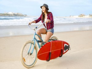 Woman riding a bike on the beach