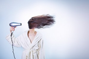 woman drying her hair