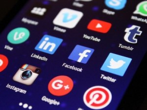 Social Media Masterclass - A phone with popular social media apps, such as Twitter, Facebook, Pinterest and Instagram