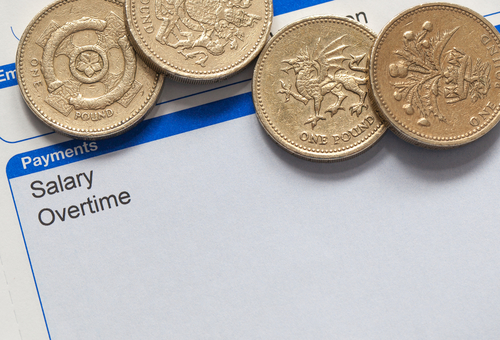 wage slip with pound coins, national minimum wage