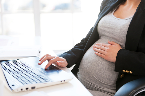pregnant woman working at desk, pregnant women