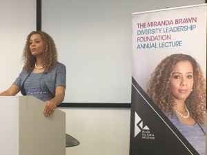 Miranda Brawn speaking at the UK's first diversity lecture on a podium
