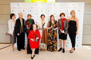 A group of smiling happy women winnign awards at the 2016 Women of the Year Awards