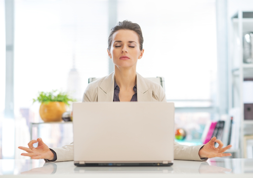 business-woman-meditating-at-her-desk-meditation