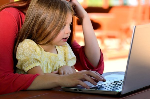 children learning to use computer with parent